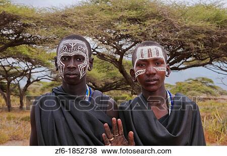 Tanzania Serengeti Africa Masai Maasai boys in black clothes from circumcision ceremony with face paint 7 View Large Photo Image Stock Photo - Tanzania Serengeti Africa Masai Maasai boys in black clothes from circumcision ceremony with face paint 7. Fotosearch