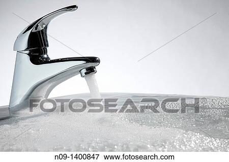 tap in the bathroom with water and foam View Large Photo Image Stock Photo - tap in the bathroom with water and foam. Fotosearch