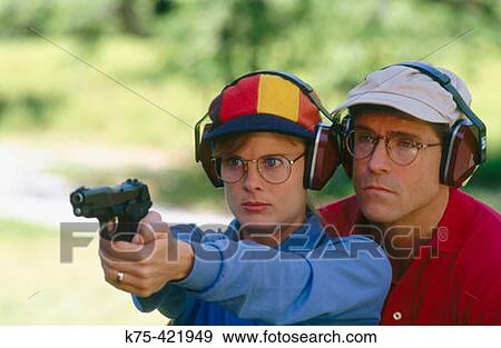 Stock Photo - Target practice with 9mm pistol. Fotosearch