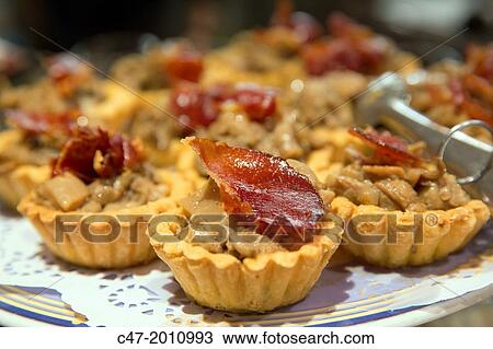 Tartlets with Jabugo ham and mushrooms. Pintxos, San Sebastian (Donostia), Basque Country, Spain View Large Photo Image Stock Image - Tartlets with Jabugo ham and mushrooms. Pintxos, San Sebastian (Donostia), Basque Country, Spain. Fotosearch