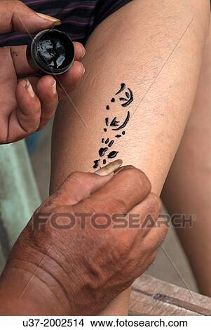 Picture - Tattoist at work, Coral Island, Pattaya, Thailand.. Fotosearch