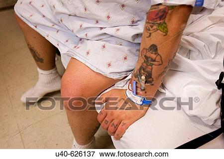 Tattooed man in hospital gown. View Large Photo Image Stock Photo - Tattooed man in hospital gown.. Fotosearch