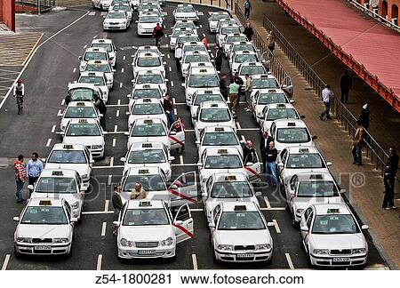 Stock Image - Taxi cabs queing for customers at Atocha stations, Madrid, Spain. Fotosearch
