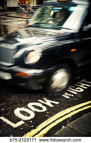 Taxi circulating about a text written in the asphalt Look Right in London, England, UK, Europe. View Large Photo Image Stock Image - Taxi circulating about a text written in the asphalt Look Right in London, England, UK, Europe.. Fotosearch