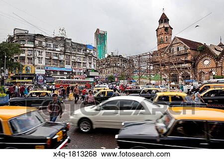 Taxis, cars, bikes and pedestrians try driving on the streets of Mumbai View Large Photo Image Stock Photo - Taxis, cars, bikes and pedestrians try driving on the streets of Mumbai. Fotosearch