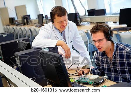 Stock Photography - Teacher and student, Laboratory digital signal processing, Computer room, Telecommunications, Electronics and Communications Unit, CEIT (Center of Studies and Technical Research), University of Navarra, Donostia, Gipuzkoa, Basque Country, Spain. Fotosearch
