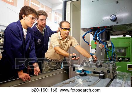 Stock Photograph - Teacher and students do their training center 3-axis machining, Applied Mechanics, Tecnun, School of Engineering of San Sebastian, University of Navarra, Donostia, Gipuzkoa, Basque Country, Spain. Fotosearch