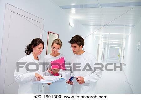 Stock Image - Teacher and students in hallway BioMEMS laboratory Research of surface chemistry and biological interactions for BioMEMS bio functionalization. Fotosearch