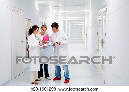 Stock Photo - Teacher and students in hallway BioMEMS laboratory Research of surface chemistry and biological interactions for BioMEMS bio functionalization. Fotosearch