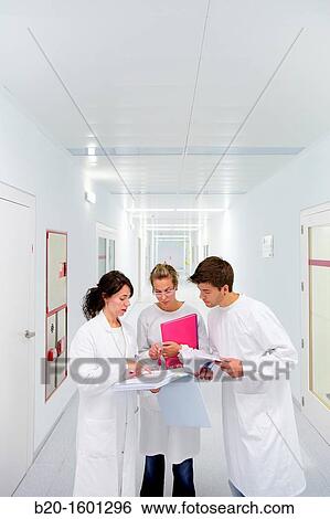 Teacher and students in hallway BioMEMS laboratory Research of surface chemistry and biological interactions for BioMEMS bio functionalization View Large Photo Image Stock Photograph - Teacher and students in hallway BioMEMS laboratory Research of surface chemistry and biological interactions for BioMEMS bio functionalization. Fotosearch