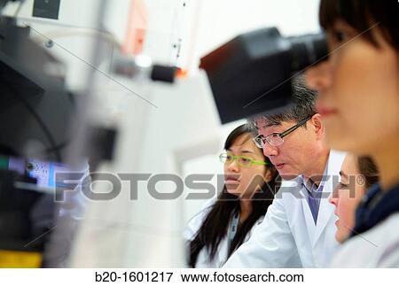 Teacher and students. Inverted optical microscope. View Large Photo Image Stock Photo - Teacher and students. Inverted optical microscope.. Fotosearch