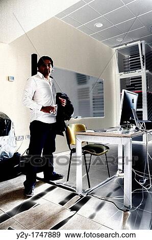 Stock Photo - Teacher and web-designer just arriving at work. Fotosearch