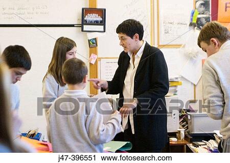 Teacher telling some children off, in classroom of 12 year olds View Large Photo Image Stock Image - Teacher telling some children off, in classroom of 12 year olds. Fotosearch