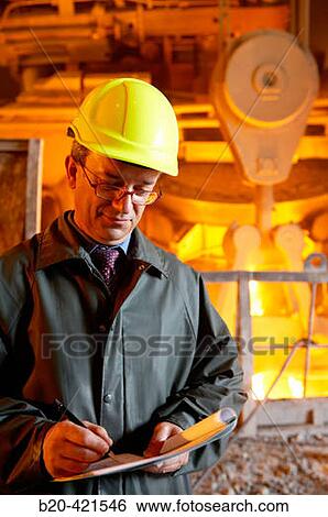 Stock Photograph - Technician and furnace in foundry, steel industry. Biscay, Euskadi, Spain. Fotosearch