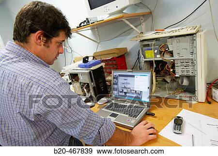 Technician fixing laptop computer at computer store View Large Photo Image Stock Photo - Technician fixing laptop computer at computer store. Fotosearch