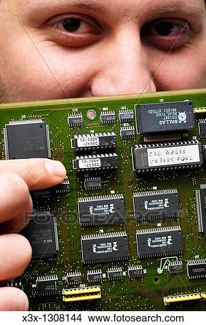 Technician holding a circuit board View Large Photo Image Picture - Technician holding a circuit board. Fotosearch