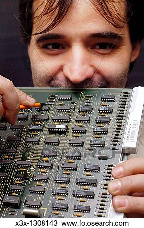 Technician holding a circuit board View Large Photo Image Stock Image - Technician holding a circuit board. Fotosearch