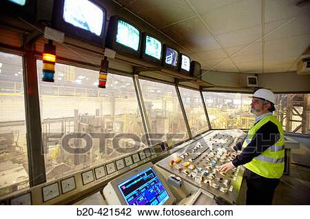 Stock Image - Technician in control room of laminating line, steel industry. Biscay, Euskadi, Spain. Fotosearch