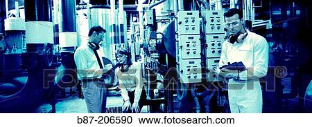 Stock Image - Technicians at factory. Fotosearch