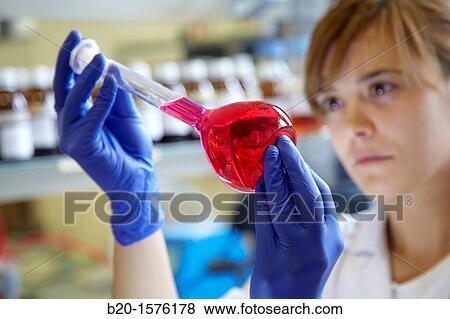 Stock Photo - Technicians get a solutions in flask, Laboratory quality control, Pharmaceutical plant, Research Center, Pharmacy, Area Health, Tecnalia Research & Innovation, Araba Technology Park, Miano, Basque Country, Spain. Fotosearch