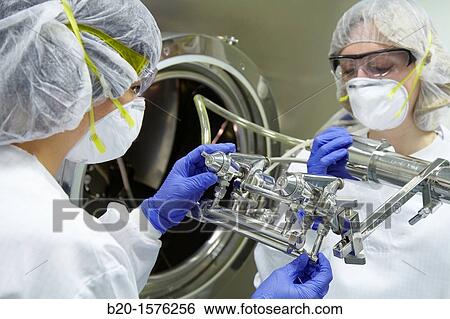 Technicians performing maintenance functions on a solid coating machine, Clean room, Pharmaceutical plant, Drug manufacturing plant, Pharmacy, Area Health, Tecnalia Research & Innovation, Araba Technology Park, Miano, Basque Country, Spain View Large Photo Image Stock Photograph - Technicians performing maintenance functions on a solid coating machine, Clean room, Pharmaceutical plant, Drug manufacturing plant, Pharmacy, Area Health, Tecnalia Research & Innovation, Araba Technology Park, Miano, Basque Country, Spain. Fotosearch