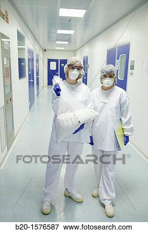 Stock Photo - Technicians with drug samples, Clean room, Pharmaceutical plant, Drug manufacturing plant, Research Center, Pharmacy, Area Health, Tecnalia Research & Innovation, Araba Technology Park, Miano, Basque Country, Spain. Fotosearch