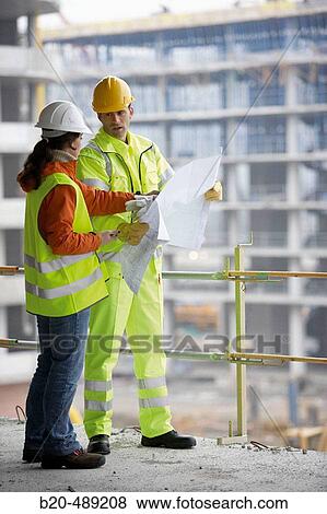 Technicians with reflective clothes and safety equipment. Housing construction, apartments. San Sebastian, Gipuzkoa, Euskadi. Spain. View Large Photo Image Stock Photo - Technicians with reflective clothes and safety equipment. Housing construction, apartments. San Sebastian, Gipuzkoa, Euskadi. Spain.. Fotosearch