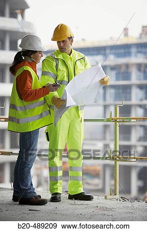 Technicians with reflective clothes and safety equipment. Housing construction, apartments. San Sebastian, Gipuzkoa, Euskadi. Spain. View Large Photo Image Stock Photo - Technicians with reflective clothes and safety equipment. Housing construction, apartments. San Sebastian, Gipuzkoa, Euskadi. Spain.. Fotosearch