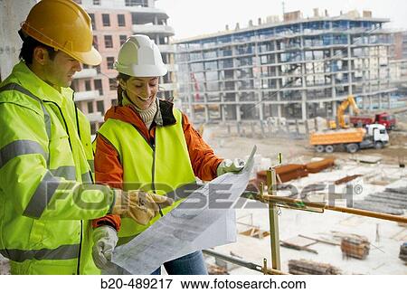 Stock Photo - Technicians with reflective clothes and safety equipment. Housing construction, apartments. San Sebastian, Gipuzkoa, Euskadi. Spain.. Fotosearch