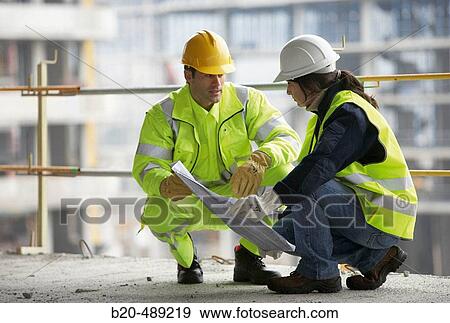 Stock Photo - Technicians with reflective clothes and safety equipment. Housing construction, apartments. San Sebastian, Gipuzkoa, Euskadi. Spain.. Fotosearch