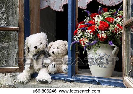 Stock Photograph - Teddies and flowers in window, Sk? ne, Sweden. Fotosearch