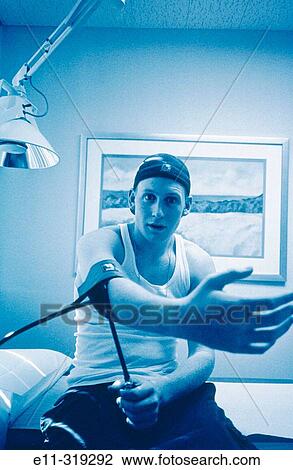 Stock Image - Teen boy in doctor's office. Fotosearch