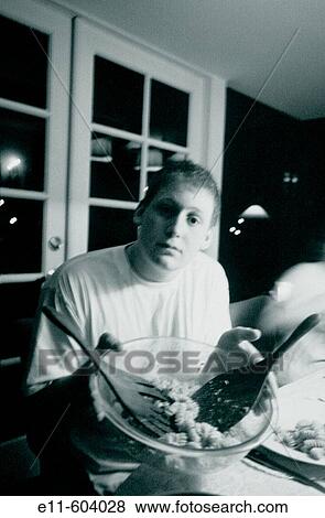 Teen boy, offering salad bowl View Large Photo Image Stock Photo - Teen boy, offering salad bowl. Fotosearch