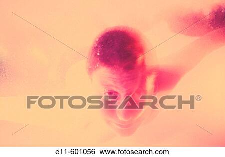 Stock Photograph - Teen boy playing in the ocean. Turks and Caicos Islands. Fotosearch