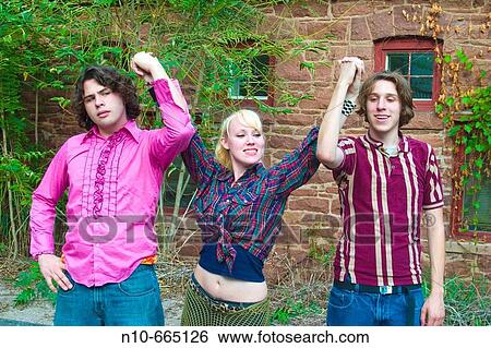 Teen boys and a teen girl holding their hands together up in the air. View Large Photo Image Stock Photograph - Teen boys and a teen girl holding their hands together up in the air.. Fotosearch