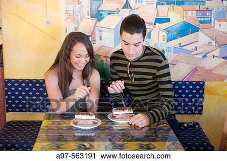 Teen couple are about to enjoy a pastry in a cafe. View Large Photo Image Stock Image - Teen couple are about to enjoy a pastry in a cafe.. Fotosearch
