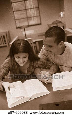 Stock Photo - Teen couple at library. Fotosearch