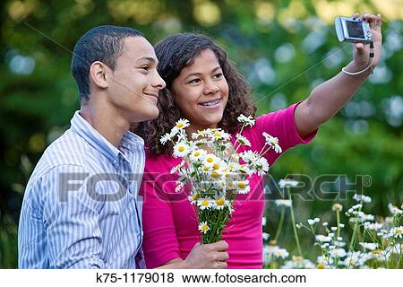 Stock Photo - Teen couple pose for self portrait. Fotosearch