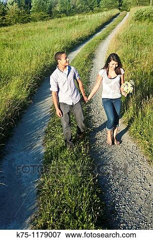 Stock Photo - Teen couple walking hand in hand. Fotosearch