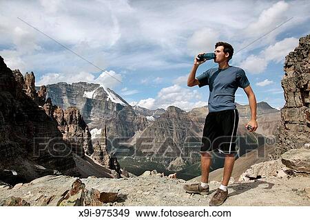 Teen drinking water after a long hike on Sentinal Pass, Banff National Park, Canada View Large Photo Image Stock Photo - Teen drinking water after a long hike on Sentinal Pass, Banff National Park, Canada. Fotosearch