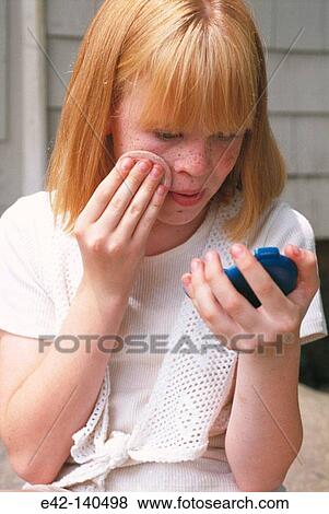 Teen girl applying make-up View Large Photo Image Stock Photo - Teen girl applying make-up. Fotosearch