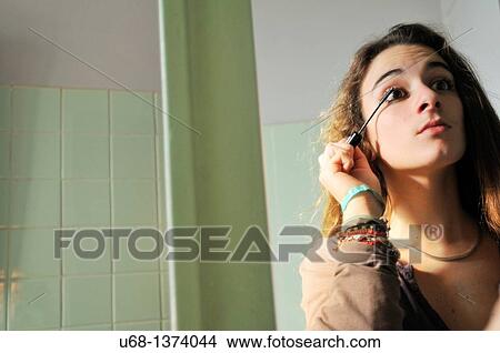 Picture - Teen girl applying mascara. Fotosearch