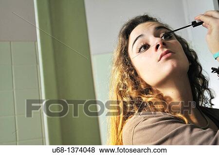 Stock Photo - Teen girl applying mascara. Fotosearch