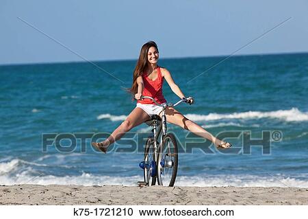 Teen girl enjoying bike ride on beach View Large Photo Image Stock Image - Teen girl enjoying bike ride on beach. Fotosearch