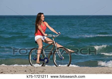 Teen girl enjoying bike ride on beach View Large Photo Image Stock Image - Teen girl enjoying bike ride on beach. Fotosearch