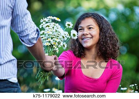 Teen girl getting a bouquet of flowers View Large Photo Image Stock Image - Teen girl getting a bouquet of flowers. Fotosearch
