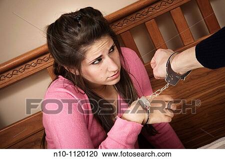 Teen girl handcuffed to her mother View Large Photo Image Stock Image - Teen girl handcuffed to her mother. Fotosearch