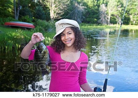 Teen girl holding her catch of the day View Large Photo Image Stock Photo - Teen girl holding her catch of the day. Fotosearch