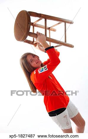 Stock Photo - Teen girl holding stool. Fotosearch