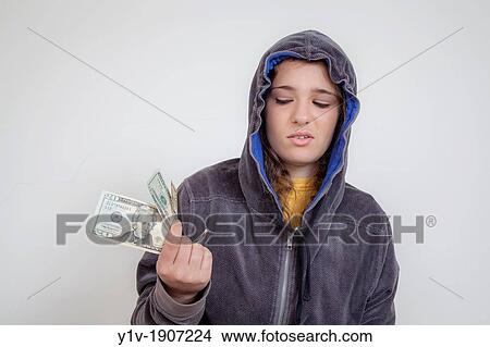 Picture - Teen girl holding United States money. Fotosearch